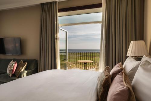 a hotel room with a bed and a large window at Rox Resort in Køge