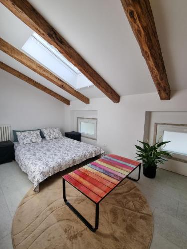 a bedroom with a bed and a table at Rozalija house - Počitniška hiša z vrtom ob reki Soči v Solkanu in Solkan