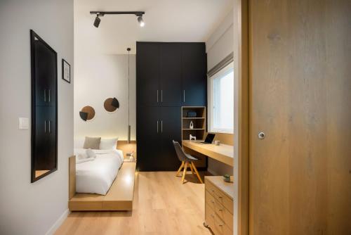 a bedroom with a bed and a desk in a room at Iconic Location Aristotelous Tsimiski in Thessaloniki