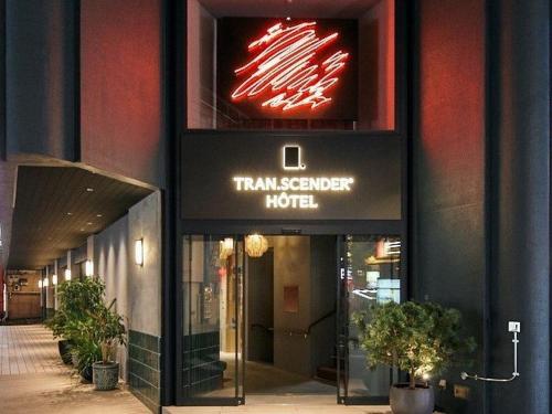 a hotel with a sign on the side of a building at TRANSCENDER HOTEL Yokohama in Yokohama