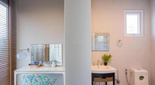 un baño con lavabo y espejo en Platinum Pool Villa, en Na Jomtien