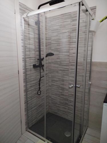 a shower with a glass door with an umbrella in it at Casa Roberta in Pacentro