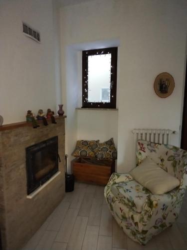 a living room with a couch and a fireplace at Casa Roberta in Pacentro