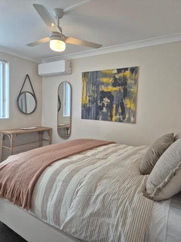 a bedroom with a bed and a ceiling fan at 2 Bed Ground Flr Gaythorne Courtyard Apt, parking in Brisbane