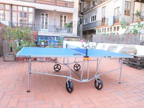 a blue ping pong table sitting on a brick ground at Soul Backpackers Barcelona in Barcelona