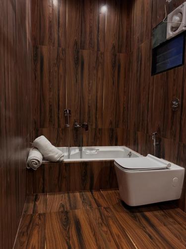 a bathroom with a tub and a sink at Silver Green Resort in Gumgaon