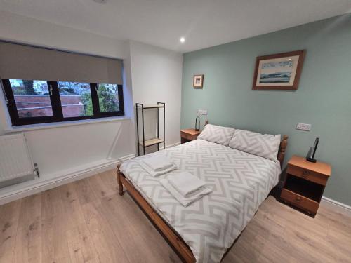 a bedroom with a bed and a window at New 4 Bed House Sleeps up to 8 People in Chepstow