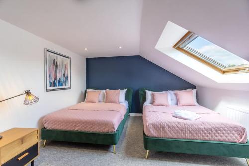 a bedroom with two beds and a window at Albion at the Level - 2 BD Flat in Brighton & Hove