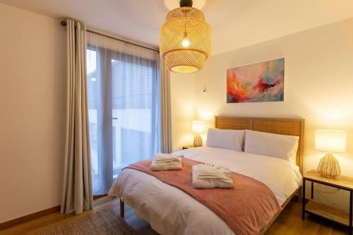 a bedroom with a bed and a large window at Elegance at the Lanes-3BD in Brighton & Hove