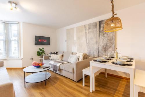 a living room with a couch and a table at Elegance at the Lanes-3BD in Brighton & Hove