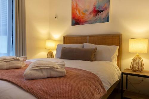 a bedroom with a large bed with two lamps at Elegance at the Lanes-3BD in Brighton & Hove