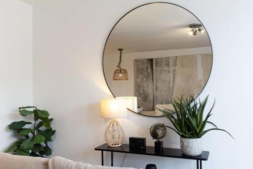 a living room with a mirror and a couch at Elegance at the Lanes-3BD in Brighton & Hove