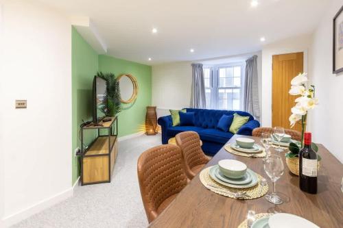 a living room with a blue couch and a table at The Regent Luxury Pad in Brighton & Hove