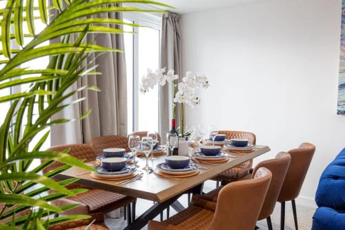 a dining room with a table and chairs at Regent Grand Penthouse in Brighton & Hove