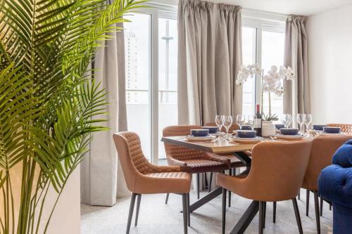 a dining room with a table and chairs at Regent Grand Penthouse in Brighton & Hove