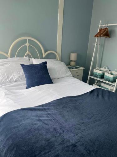 a blue and white bed with a blue pillow on it at Sandcastle Chalet in Bridlington