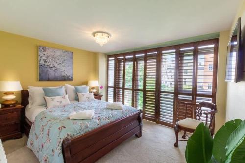 a bedroom with a large bed and windows at Luxury at The Brunswick - Free Parking-4 bedrooms in Brighton & Hove