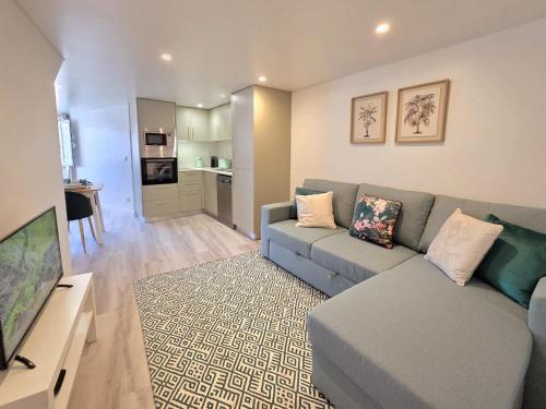 a living room with a couch and a television at Aconchego da Vila in Castelo de Vide