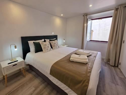 En eller flere senge i et værelse på Aconchego da Vila