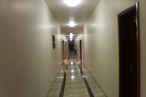 an empty hallway with a long hall with a corrid at Hotel Moon Palace Kolwezi in Kolwezi