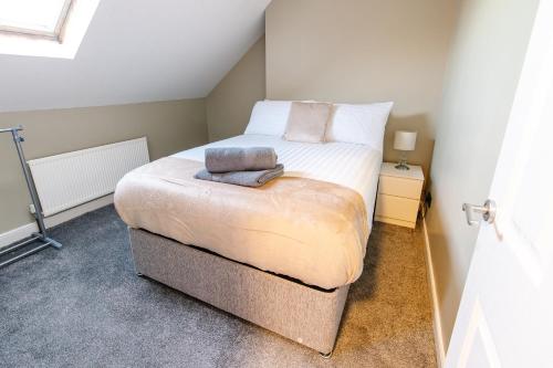 a small bedroom with a bed in a room at The Nines in Bangor