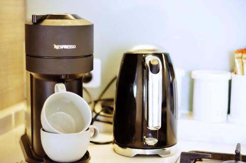 a coffee maker and a cup on a counter at Contemporary Comfort in Melbourne