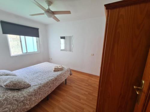 a bedroom with a bed and a ceiling fan at Jurgita Apartment in Los Llanos de Aridane