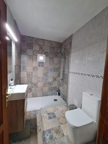 a bathroom with a tub and a toilet and a sink at Jurgita Apartment in Los Llanos de Aridane