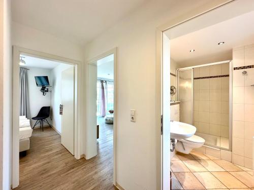 a bathroom with a white toilet and a sink at Strandoase Sierksdorf Strandoase Sonnenbucht in Hansaland