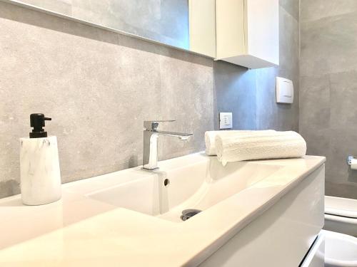 Civico 148- Lido di Jesolo - Per Famiglie في ليدو دي يسولو: حمام أبيض مع حوض ومرحاض