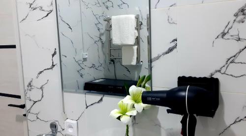 a blow dryer in a bathroom with a mirror at City Center Apartment "Afsona mall" in Irvadan