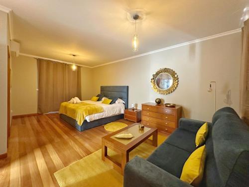 a living room with a bed and a couch at Arco da Calheta Villa in Arco da Calheta