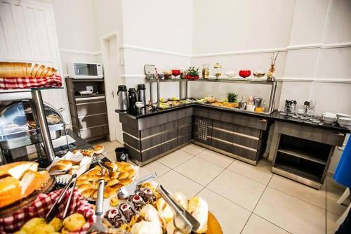 a kitchen with a bunch of food on a table at Gold - Inn Hotel in Apiaí