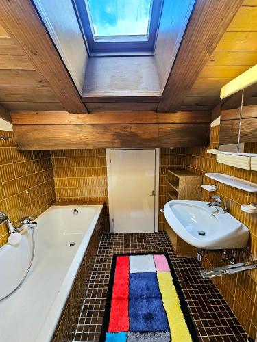 a bathroom with a tub and a sink and a bath tub at Das Landhaus in Gerlos
