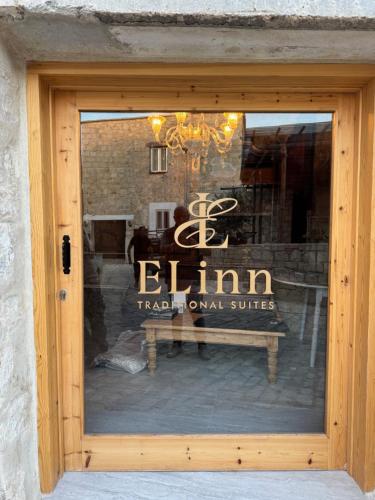 a window of a store with a bench in it at ELINN traditional suits in Kathikas
