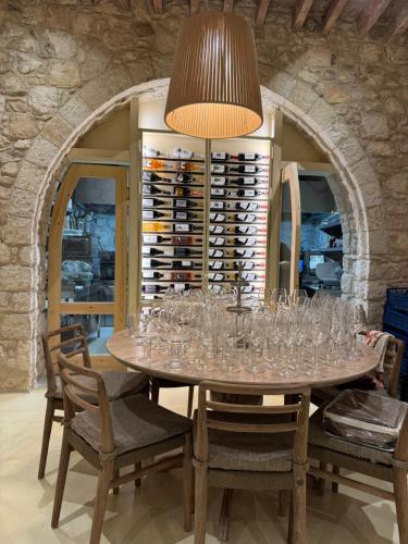 a dining room with a table with wine glasses at ELINN traditional suits in Kathikas