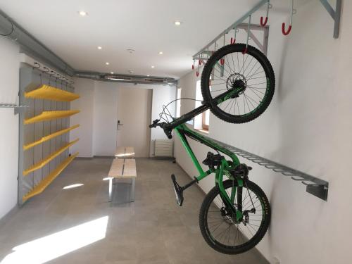 a bike hanging on a wall in a room at Riffelhaus 1853 in Zermatt