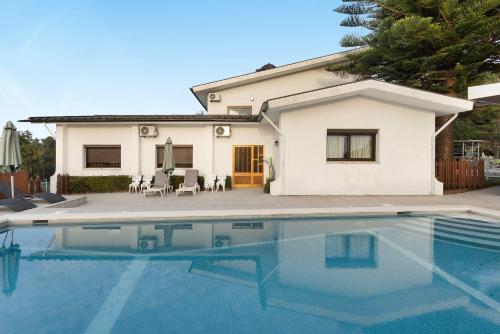 a house with a swimming pool in front of a house at Casa São Domingos 1 in Lousada