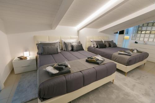 a bedroom with two beds with towels on them at ALMAR HOLIDAY - Crotone in Crotone