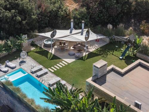 an aerial view of a backyard with a swimming pool at Thalmargia Villas, with Pool, Hot Tub & Ultimate Peace, By ThinkVilla in Garazo