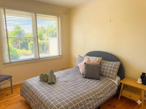 a bedroom with a bed with a teddy bear on it at The Hamlyn Haven - Sleeps 5 - Central Location in Hamlyn Heights