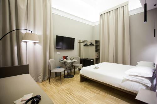 a hotel room with a bed and a table at Ripetta 25 Prestige Rooms in Rome