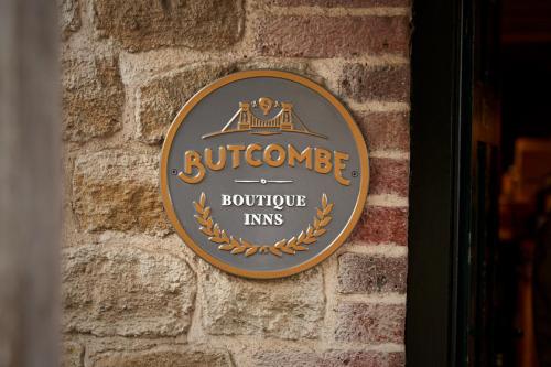 a sign on the side of a brick wall at The Welldiggers Arms in Petworth