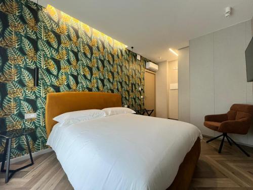 a bedroom with a large bed and a colorful wall at Telese Charme B&B in Telese