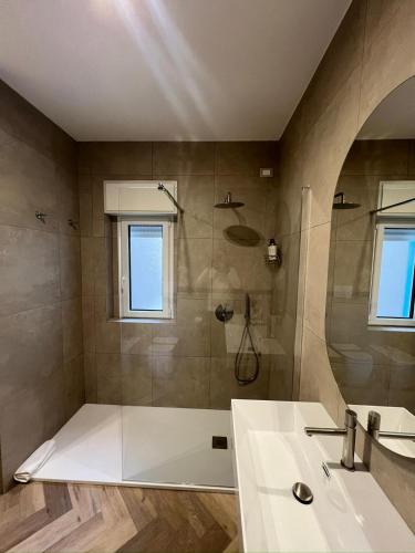 a bathroom with a tub and a sink and a shower at Telese Charme B&B in Telese