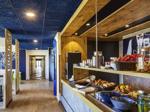 a kitchen with a counter with food on it at Ibis Budget Montpellier Aéroport Parc Des Expos in Mauguio