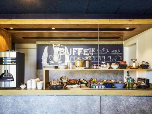 a kitchen with a counter with food on it at Ibis Budget Montpellier Aéroport Parc Des Expos in Mauguio