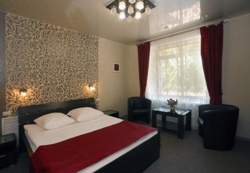 a hotel room with a bed and a window at Hotel Relax in Kirov