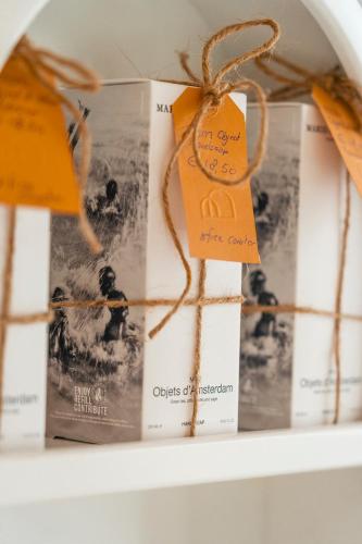 a shelf with books and tags on them at The Gentle Arch Schiphol Amsterdam in Aalsmeer