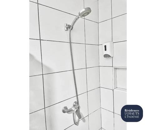 a shower with a shower head in a bathroom at Résidences Les Hauts de l'Indenié in Abidjan